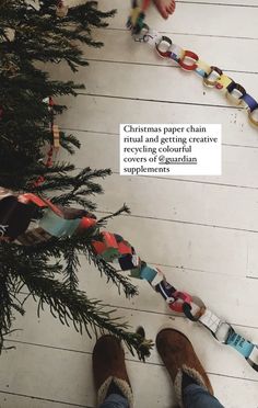 a person standing in front of a christmas tree with the words christmas paper chain ritual and getting creative