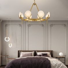 a large bed sitting under a golden chandelier