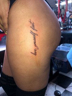 the back of a woman's thigh with writing on it