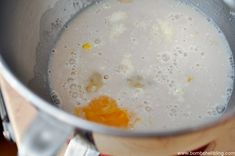 a metal pot filled with liquid on top of a stove