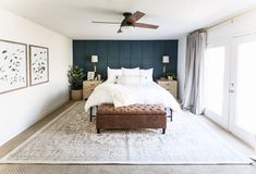 a bedroom with a bed, dressers and ceiling fan in the middle of it