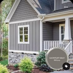 a gray house with white trim and windows