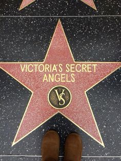 a person standing in front of a star on the hollywood walk of fame