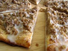 several slices of pizza sitting on top of a wooden cutting board