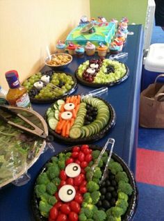 a table topped with lots of different types of vegetables and fruit in bowls on top of it