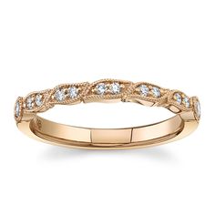 a gold wedding band with diamonds on it