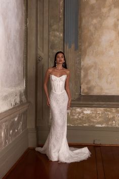 a woman in a white wedding dress posing for the camera