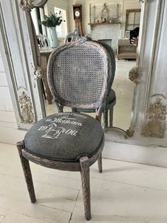 an old chair is sitting in front of a mirror with the word love written on it