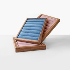 an open wooden box with blue fabric inside