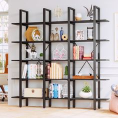 a living room filled with furniture and bookshelves