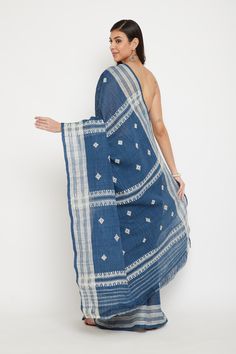 PRODUCT DETAILS: A soft, caressing silk, Ahimsa/Eri silk is a natural silk that is non-violent in nature as it does not kill the silkworm in the process of fibre extraction. The saree is handwoven in blue with traditional motifs adorning in white. The texture of the saree is unlike mulberry silks and is often mistaken for linen or cotton. Our Ahimsa silk is extracted from silk cocoons that have been fed on leaves of the wild castor plants. After the silkworms emerge from the cocoons, the empty shells are boiled silk and left to air dry. The yarn is spun by hand and then dyed with natural materials such as indigo, turmeric, lac, etc.  This Ahimsa silk saree has been: > Naturally dyed with indigo (blue)  > Woven from yarn that has been spun by hand > Handwoven on traditional looms Total sare Handloom Pre-draped Saree For Eid, Blue Bohemian Blouse With Zari Weaving, Bohemian Blue Blouse With Zari Weaving, Bohemian Handloom Pre-draped Saree For Wedding, Semi-stitched Slub Silk Handloom Saree, Eid Handloom Saree, Festive Indigo Saree With Pallu Detail, Festive Indigo Saree With Pallu, Bohemian Tussar Silk Saree For Eid