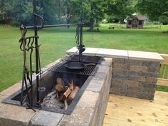 an outdoor fire pit in the middle of a park