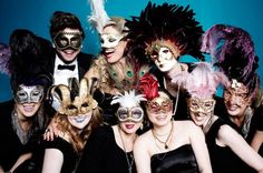 a group of people with masks posing for a photo