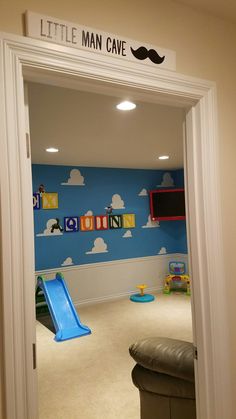 a child's playroom with blue walls and clouds on the wall is shown