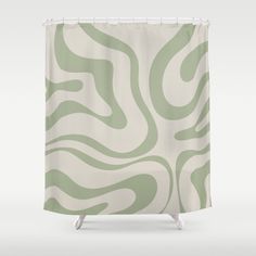 a green and white shower curtain with wavy lines