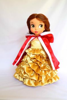 the doll is wearing a red and gold dress