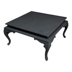 a black coffee table sitting on top of a white floor