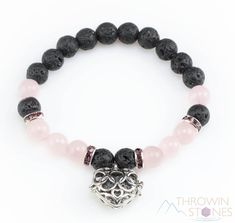 Approximate Size: One size fits all elastic 8mm wide beads Approximate Weight: 20 - 22 grams Quantity: You will receive 1 bracelet This bracelet is made with Rose Quartz and Lava Stone beads and has a silver plated heart locket charm that contains a lava stone heart diffuser. Add a few drops of your favorite essential oils to the lava heart for your own personal aromatherapy diffuser! The lava stone heart is also removable from the locket, if you want to switch it out with your favorite charm. T Lava Crystal, Power Bracelet, Lava Stone Bracelet, Aromatherapy Diffuser, Rose Quartz Bracelet, Smoky Quartz Crystal, Crystal Healing Bracelets, Diffuser Bracelets, Locket Charms