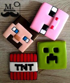 three decorated cookies sitting on top of a wooden table