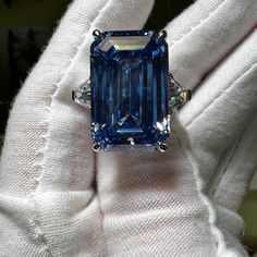 Carbon created 28CT emerald cut Swiss blue topaz statement ring.  This carbon created aquamarine has a 20% higher refractive index and 16.6% more gloss than earth mined diamonds.  🔥Looking for spectacular fire?  925 sterling silver/ 18K white gold plating 28CT carbon based aquamarine 2 x 1CT trillion cut carbon based accents stones Size  7 for immediate shipping Luxury Blue Cubic Zirconia Topaz Ring, Luxury Exquisite Topaz Wedding Ring, Luxury Blue Topaz Diamond Cut Jewelry, Luxury Brilliant Cut Topaz Ring In Fine Jewelry Style, Luxury Dazzling Blue Topaz Rings, Luxury Topaz Birthstone Gemstones, Blue Radiant-cut Emerald Ring In Fine Jewelry Style, Blue Radiant Cut Emerald Ring In Fine Jewelry, Blue Radiant-cut Emerald Ring Fine Jewelry