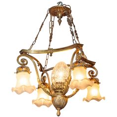 an antique chandelier with five lights hanging from it's chain and glass shades