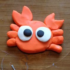 an orange crab with googly eyes on it's face