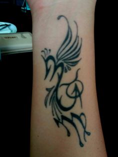 a woman's arm with a tattoo design on the left side of her wrist