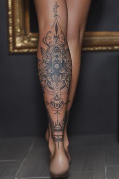 a woman's legs with tattoos on them and a mirror in the back ground