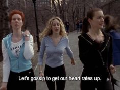 three women are walking down the street together