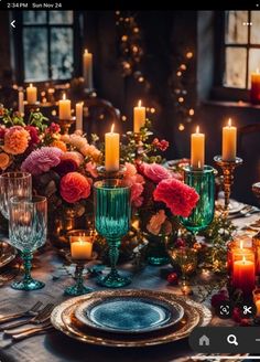 an image of a table setting with candles and flowers in the center, surrounded by other place settings