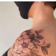 a woman with a flower tattoo on her shoulder