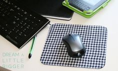 a mouse pad with a black and white checkered pattern on it next to a laptop