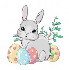 a rabbit sitting next to three decorated eggs