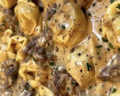 pasta with mushrooms and sauce in a white bowl