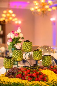 a table topped with lots of fruit and flowers