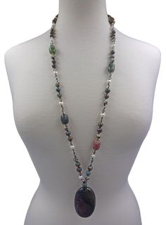 "Indian Agate Oval Necklace. A Large Natural High-Polished Oval Shaped Indian Agate Pendant That Reflects Multi-Color Tones in Brown, Dark Green, and Dark Grey Tones. It Connects to A Multi Gem Stone Necklace. Each Bead Is Hand-Knotted with Great Cord Strength. Necklace: 34\" L. Pendant: 1.50\" W x 2.25\" L. Clasp: NA Material: Indian agate/ocean jasper/dalmatian jasper/cultured fresh water pearl/hematite/crystal/no metal type Beaded/each bead is knotted" Bohemian Oval Agate Necklace, Spiritual Oval Multicolor Necklaces, Multicolor Oval Spiritual Necklaces, Oval Agate Gemstone Beaded Necklaces, Oval Agate Gemstone Bead Necklaces, Adjustable Oval Necklace With Natural Stones, Multicolor Oval Beads Gemstone Necklaces, Multicolor Oval Spiritual Jewelry, Oval Beaded Necklaces With Natural Stones For Gifts