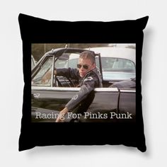 a black pillow with the words racing for pinks punk in front of a photo of a man wearing sunglasses