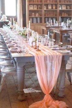 a long table is set with candles and place settings