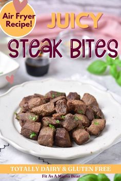 Steak bites on a white plate with parsley on them with text on the image. Spicy Beef