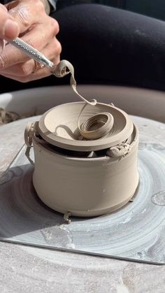 a person is working on an object in the process of making something out of clay