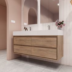 a bathroom with a sink, mirror and tiled flooring in pink tones on the walls