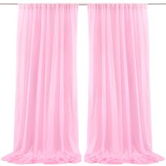 two pink curtains hanging on a metal rod