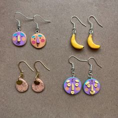 six pairs of earrings with different designs on them, including one moon and the other half