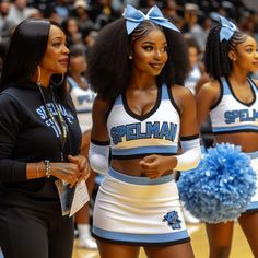 two women in cheerleader outfits standing next to each other