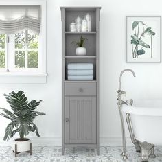 a bathroom with a white bathtub and sink next to a window filled with plants