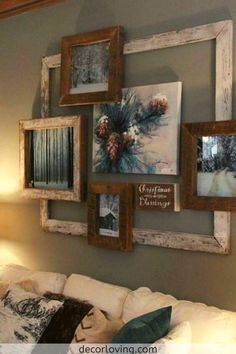 a living room filled with white furniture and pictures hanging on the wall above couches