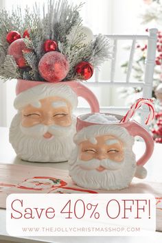 two santa mugs with christmas decorations on top and the words save 40 % off