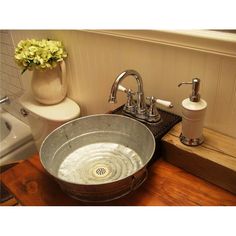 a bathroom with a sink, toilet and bathtub on the counter next to it