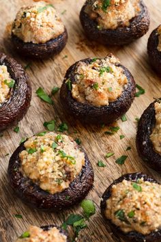 stuffed mushrooms with cheese and herbs on a cutting board