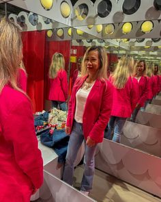 a woman standing in front of a mirror